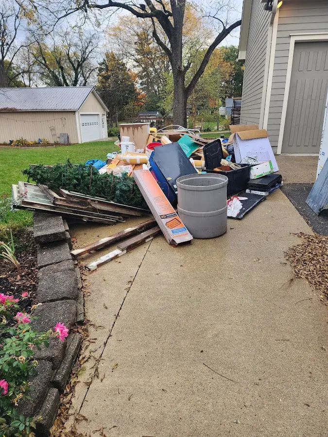 Dumpster being loaded with debris for Estate Cleanout Dumpster Rental in Bayou Blue